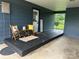 Cozy covered porch featuring seating, a welcome sign, and a tranquil outdoor space at 60 White Oaks Dr, Taylorsville, NC 28681