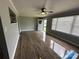 Spacious living room with hardwood floors, ceiling fan, and large window with natural light at 60 White Oaks Dr, Taylorsville, NC 28681