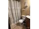 Compact bathroom with decorative shower curtain and neutral tile at 6039 Donna Dr, Charlotte, NC 28213