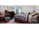Bedroom with a plaid comforter on the bed and a dedicated desk area at 6039 Donna Dr, Charlotte, NC 28213