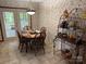 Charming dining area with a classic chandelier, and adjacent access to an outdoor living space at 6039 Donna Dr, Charlotte, NC 28213