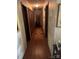 Well-lit hallway with wood flooring and doors to other rooms at 6039 Donna Dr, Charlotte, NC 28213