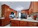 Eat-in kitchen features wood cabinets, appliances, and a breakfast bar for added convenience at 6039 Donna Dr, Charlotte, NC 28213