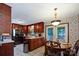 Eat-in kitchen features wood cabinets, appliances, and access to outdoor living at 6039 Donna Dr, Charlotte, NC 28213