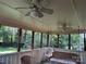 Relaxing screened porch features ceiling fans and a comfortable hanging swing for leisure at 6039 Donna Dr, Charlotte, NC 28213