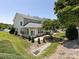 Aerial view of a home's backyard, featuring a patio and lush greenery at 621 Pine Links Dr, Tega Cay, SC 29708