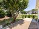 The backyard patio is set amongst other houses, a tree, and low bushes at 621 Pine Links Dr, Tega Cay, SC 29708