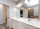 Clean bathroom with double sink, large mirror and vanity with access to the shower and hallway at 621 Pine Links Dr, Tega Cay, SC 29708