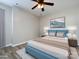 Staged bedroom with modern bed frame, wood flooring, and a ceiling fan at 621 Pine Links Dr, Tega Cay, SC 29708