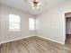 Bedroom featuring wood flooring, two large windows, and neutral wall color at 621 Pine Links Dr, Tega Cay, SC 29708