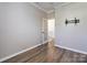 Neutral bedroom with hardwood flooring, crown moulding, and a door to hallway at 621 Pine Links Dr, Tega Cay, SC 29708
