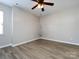 Empty bedroom with wood floors, ceiling fan, and neutral colored walls at 621 Pine Links Dr, Tega Cay, SC 29708