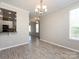 Light-filled dining space with open access to the kitchen and other rooms at 621 Pine Links Dr, Tega Cay, SC 29708