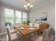Bright dining room featuring a wood table and buffet under a modern light fixture at 621 Pine Links Dr, Tega Cay, SC 29708
