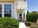 Inviting entryway with a well-lit porch and manicured shrubs at 621 Pine Links Dr, Tega Cay, SC 29708