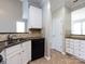 Practical kitchen featuring white cabinets, black appliances, dark countertops and tile flooring at 621 Pine Links Dr, Tega Cay, SC 29708