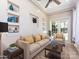 Bright living room features recessed lighting, ceiling fan and decor shelving around a comfortable sofa with yellow throw pillows at 621 Pine Links Dr, Tega Cay, SC 29708
