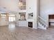 Open concept living room with a fireplace, staircase and connection to the kitchen at 621 Pine Links Dr, Tega Cay, SC 29708