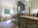 Bright primary bathroom with dual sinks, tub and a large window at 6311 Red Maple Dr, Charlotte, NC 28277