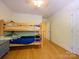Functional bedroom featuring hardwood floors, bunk beds, and ample space at 6311 Red Maple Dr, Charlotte, NC 28277