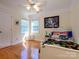 Cozy bedroom features hardwood floors, two windows, and comfortable furnishings for relaxing at 6311 Red Maple Dr, Charlotte, NC 28277
