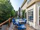 Outdoor deck features a dining set with blue cushions and beautiful backyard views at 6311 Red Maple Dr, Charlotte, NC 28277