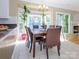 Sunlit breakfast nook with a view of the fireplace through the doorway at 6311 Red Maple Dr, Charlotte, NC 28277