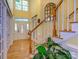 Grand foyer featuring a staircase and transom windows, complemented by hardwood floors at 6311 Red Maple Dr, Charlotte, NC 28277