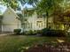 Charming two-story home with manicured lawn, lovely garden and a welcoming front porch perfect for relaxation at 6311 Red Maple Dr, Charlotte, NC 28277