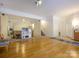 Expansive living area with hardwood floors, large windows, and room for versatile arrangements at 6311 Red Maple Dr, Charlotte, NC 28277