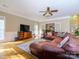 Spacious living room with a large sectional sofa, fireplace, and hardwood flooring at 6311 Red Maple Dr, Charlotte, NC 28277