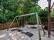Backyard playground area with swings, pea gravel, and mature trees for endless outdoor fun at 6311 Red Maple Dr, Charlotte, NC 28277