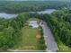 Scenic aerial view of community amenities with pool, grassy park, parking and lake in the background at 6326 Jepson Ct, Charlotte, NC 28214