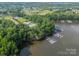 Aerial view of a community with lake access, a swimming pool, tennis courts, and boat docks at 6326 Jepson Ct, Charlotte, NC 28214