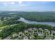 An aerial view of beautiful homes near a lake, surrounded by lush trees, showcasing the community at 6326 Jepson Ct, Charlotte, NC 28214