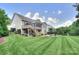 Expansive backyard showcasing meticulous landscaping, a spacious lawn, and screened-in porch at 6326 Jepson Ct, Charlotte, NC 28214