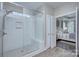 Modern bathroom featuring a glass-enclosed shower with tiled walls and a convenient bench at 6326 Jepson Ct, Charlotte, NC 28214