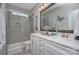 Bright bathroom featuring double vanity with quartz counters and tiled glass shower enclosure at 6326 Jepson Ct, Charlotte, NC 28214