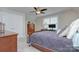 Comfortable bedroom featuring a ceiling fan, wooden dresser, and a large window at 6326 Jepson Ct, Charlotte, NC 28214