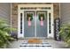 Inviting double front doors adorned with wreaths, a decorative welcome mat, and fresh fern accents at 6326 Jepson Ct, Charlotte, NC 28214