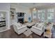 Comfortable living room with a fireplace, built-in shelving, and plenty of natural light at 6326 Jepson Ct, Charlotte, NC 28214