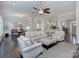 Open-concept living room with hardwood floors, comfortable seating, and abundant natural light at 6326 Jepson Ct, Charlotte, NC 28214