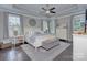 Spacious main bedroom featuring a tray ceiling, large windows, and elegant furnishings at 6326 Jepson Ct, Charlotte, NC 28214
