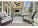 Inviting covered patio featuring comfortable seating, ceiling fan, and mounted TV for outdoor enjoyment at 6326 Jepson Ct, Charlotte, NC 28214