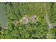 Aerial view of the secluded home surrounded by lush, mature trees at 640 Lochaven Rd, Weddington, NC 28173