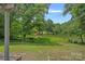 Enjoy a serene view of the lush lawn and pond from the backyard at 640 Lochaven Rd, Weddington, NC 28173