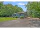 Exterior of the charming blue home, featuring well-maintained landscaping and a private driveway at 640 Lochaven Rd, Weddington, NC 28173