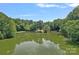 Picturesque lake view showcasing lush trees and reflections on the calm water at 640 Lochaven Rd, Weddington, NC 28173