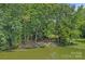 Beautiful lakeside property with lush trees, calm water, and a peaceful setting at 640 Lochaven Rd, Weddington, NC 28173