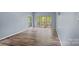Cozy living room featuring wood-look laminate flooring and access to a screened-in porch at 640 Lochaven Rd, Weddington, NC 28173